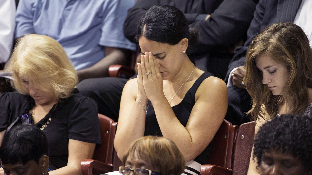 Mourners pray during the service.