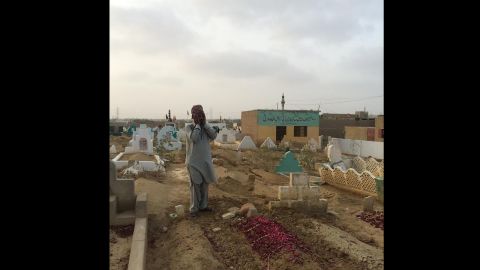 Sameer prays at the graves of his children. Ten people died because of heat related ailments in this neighbourhood alone.