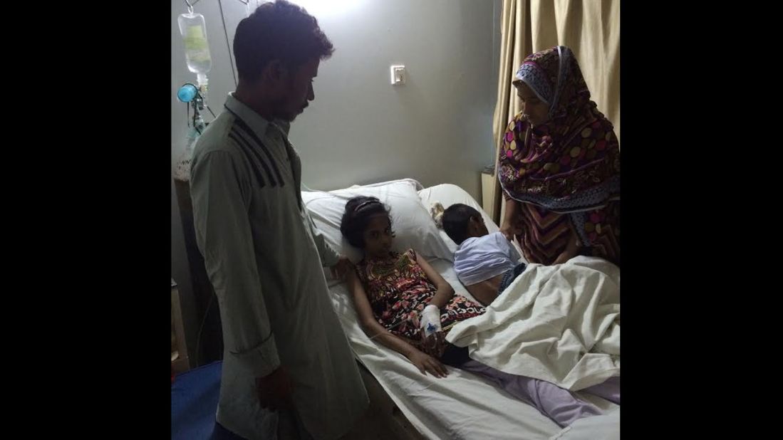 Sameer's wife Husna holds vigil by her children's bedside. They are depending on charity to continue keeping them in the hospital.