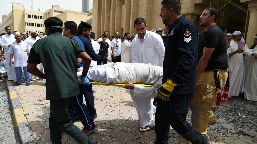Kuwaiti security personnel and medical staff carry a man on a stretcher at the site of a suicide bombing that targeted the Shiite Al-Imam al-Sadeq mosque after it was targeted by a suicide bombing during Friday prayers on June 26, 2015, in Kuwait City.
