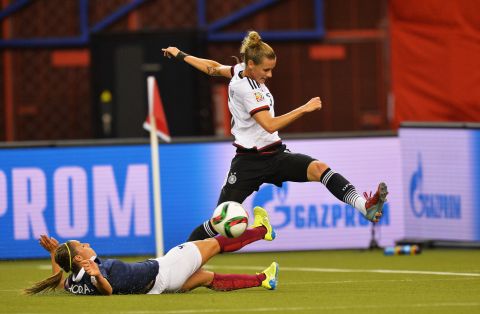 Germany's Simone Laudehr, right, is challenged by Jessica Houara of France during a quarterfinal match in Montreal on June 26. Germany advanced after winning a penalty shootout.