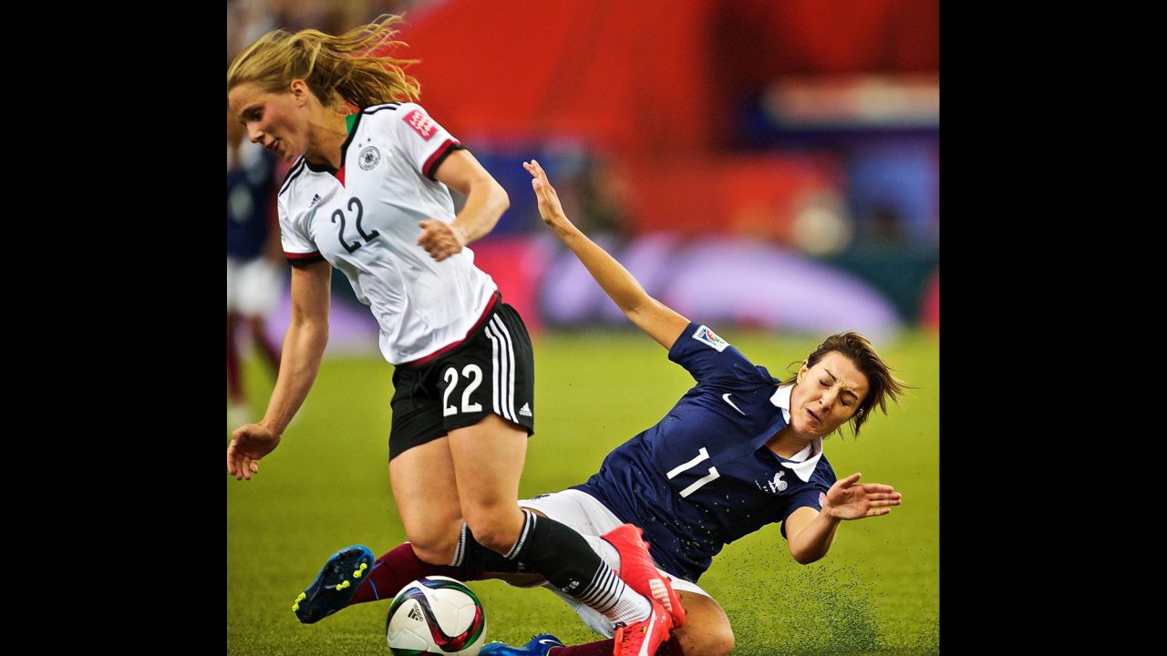 French midfielder Claire Lavogez slides in on  German midfielder Tabea Kemme.