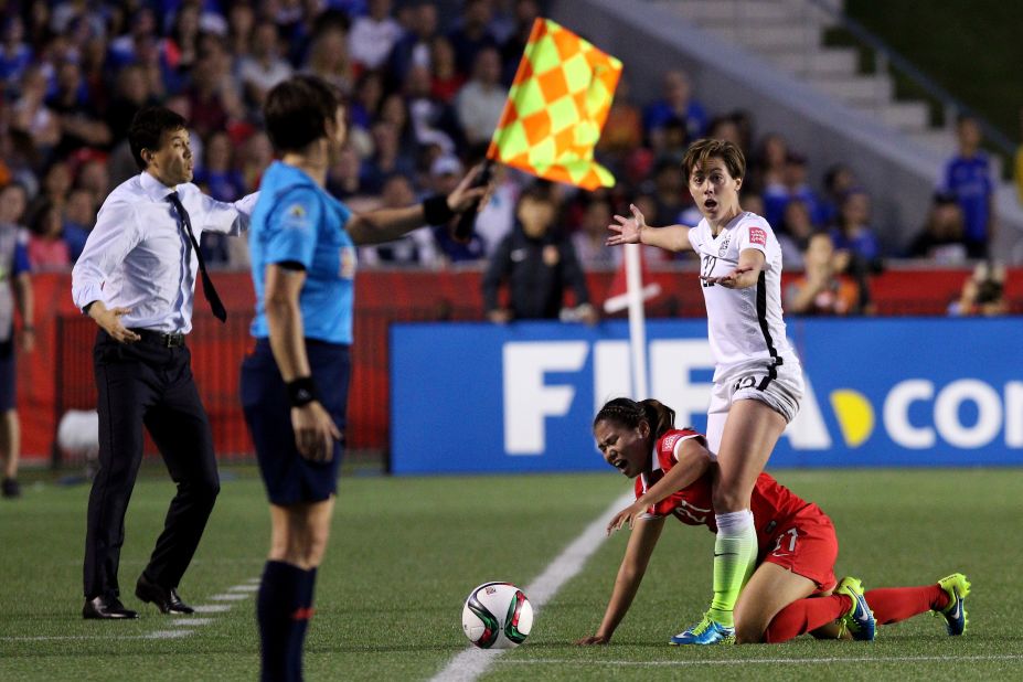 U.S. defender Meghan Klingenberg stands over China's Wang Lisi during a match in Ottawa on Friday, June 26. The United States won 1-0 to advance to the semifinals.