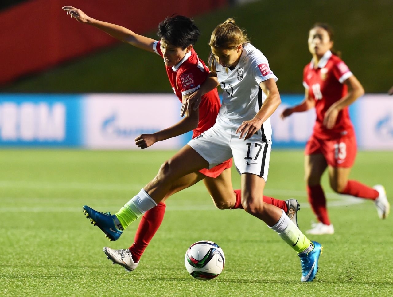 U.S. midfielder Tobin Heath fights for the ball with China's Pang Fengyue.