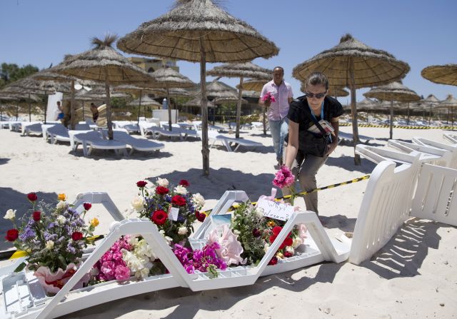 People lay flowers on the beach in front of Hotel Riu Imperial Marhaba, in the coastal city of Sousse, Tunisia, on Saturday, June 27. Gunmen <a href="index.php?page=&url=http%3A%2F%2Fwww.cnn.com%2F2015%2F06%2F26%2Fafrica%2Ftunisia-terror-attack%2Findex.html" target="_blank">killed at least 38 people at site</a>, the same day terrorists lashed out brutally in France and bombed a mosque in Kuwait.