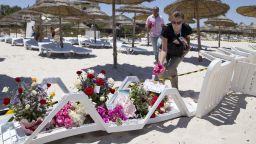 People lay flowers at the site of a shooting attack on the beach in front of the Riu Imperial Marhaba Hotel in Port el Kantaoui, on the outskirts of Sousse south of the capital Tunis, on June 27, 2015. The Islamic State (IS) group claimed responsibility on June 27 for the massacre in the seaside resort that killed nearly 40 people, most of them British tourists, in the worst attack in the country's recent history. AFP PHOTO / KENZO TRIBOUILLARD        (Photo credit should read KENZO TRIBOUILLARD/AFP/Getty Images)
