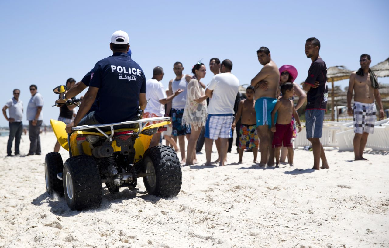 Tunisian police patrol the beach in front of the Riu Imperial Marhaba Hotel on June 27.