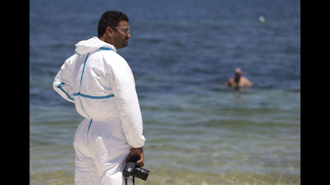 A Tunisian forensics expert inspects the beach on June 27.