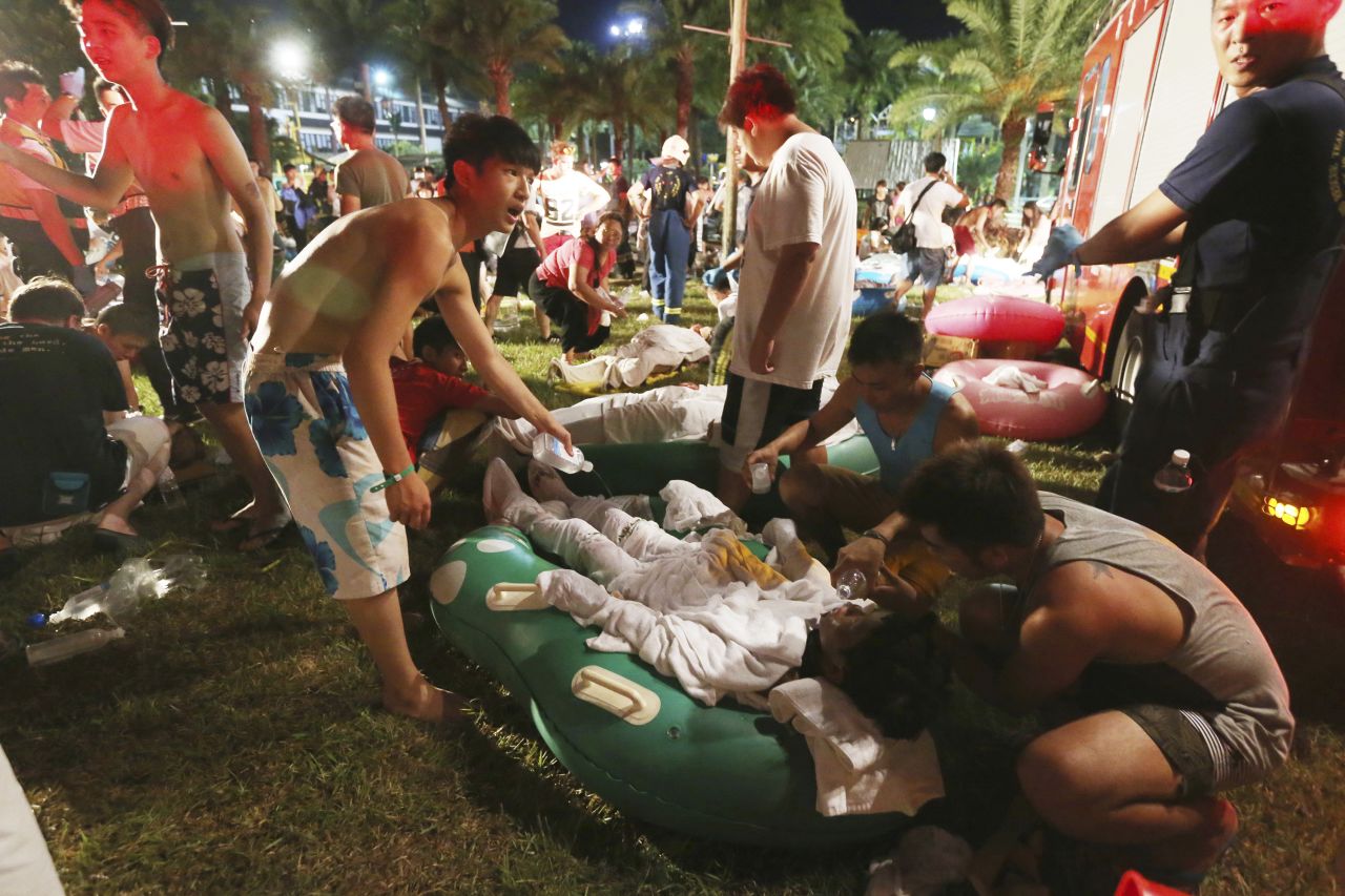 Emergency rescue workers and concert spectators tend to injured victims at the Formosa Water Park in New Taipei City, Taiwan, Saturday, June 27, after flammable powder apparently exploded in mid-air, according to the East Asian nation's official Central News Agency reported.
