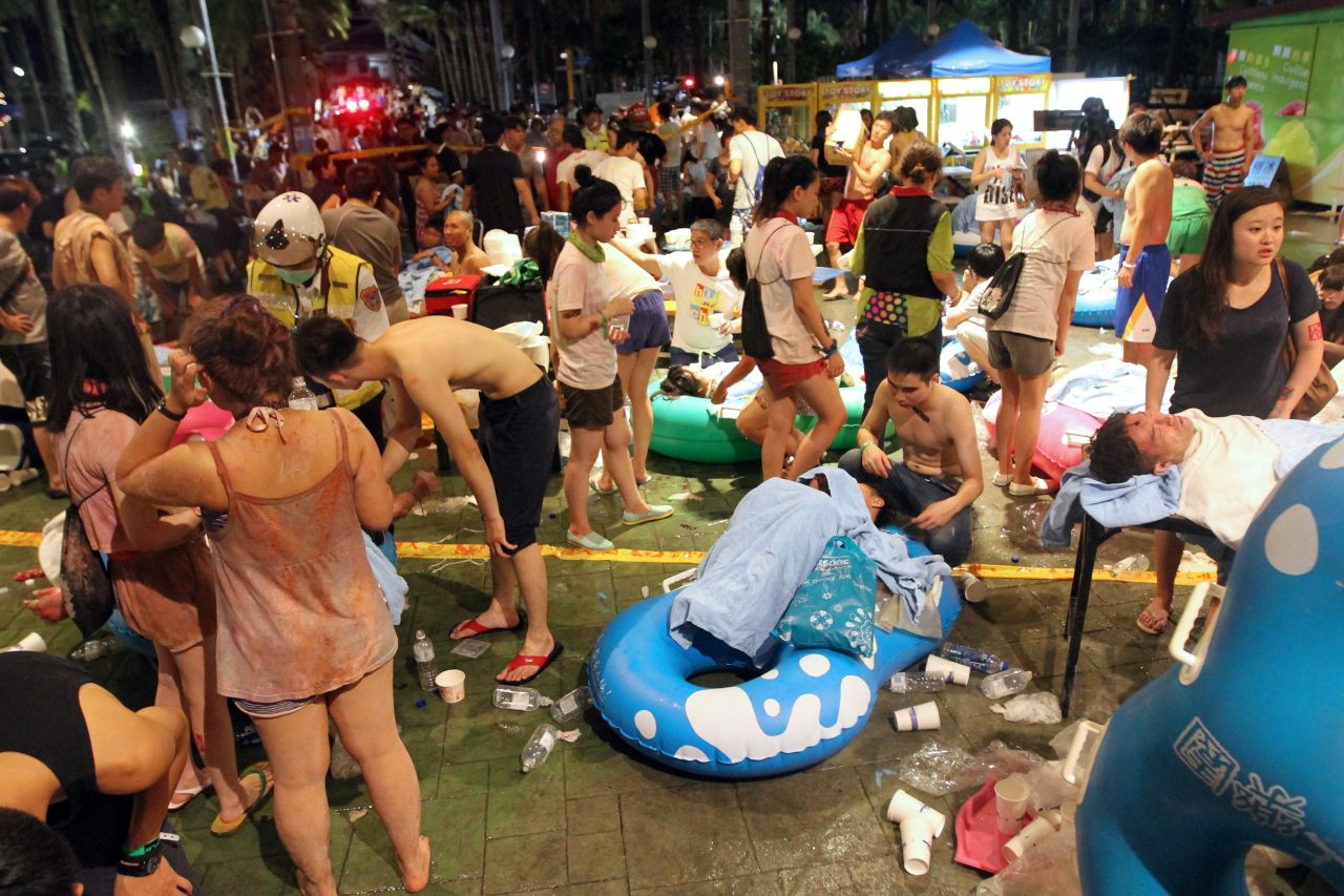 Rescue workers tend to injured people at the Formosa Fun Coast amusement park after an explosion in the Pali district of New Taipei City on June 27, 2015.