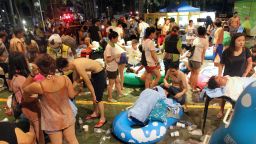 Rescue workers tend to injured people at the Formosa Fun Coast amusement park after an explosion in the Pali district of New Taipei City on June 27, 2015. More than 200 people were injured, over 80 of them seriously, in an explosion at an amusement park outside Taiwan's capital Taipei Saturday after coloured powder being sprayed onto a crowd ignited, officials said. AFP PHOTO / STR ***TAIWAN OUT*** (Photo credit should read -/AFP/Getty Images)