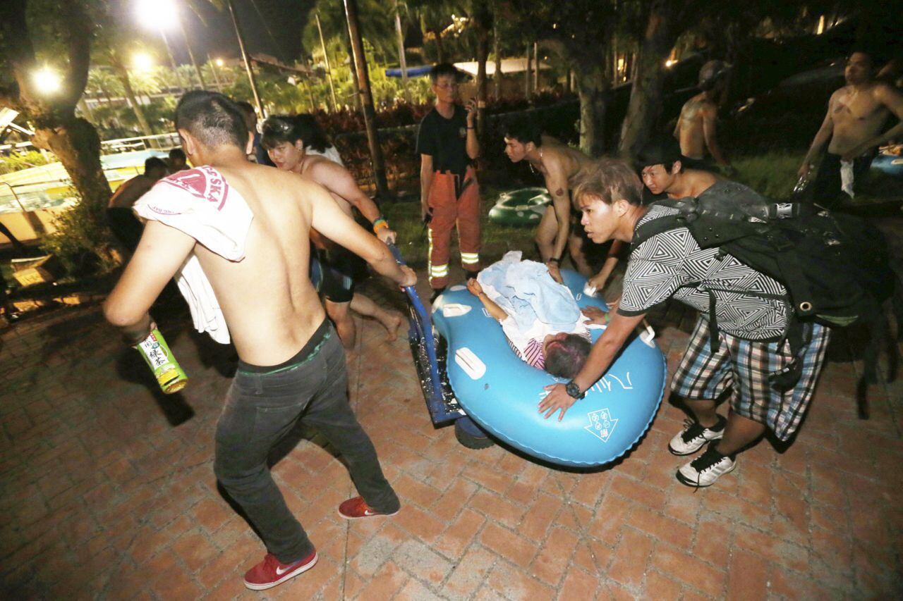 Concert spectators tend to injured victims after an accidental explosion.