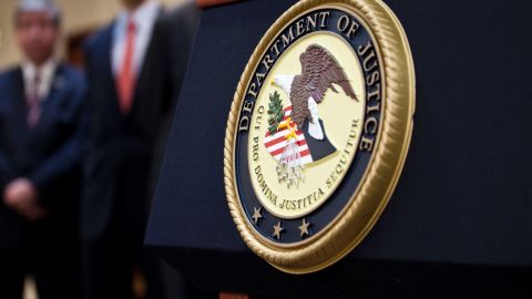 US Department of Justice seal is displayed on a podium during a news conference to announce money laundering charges against HSBC on December 11, 2012 in the Brooklyn borough of New York City. 