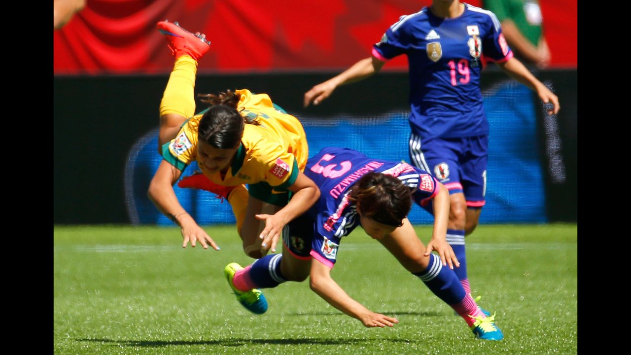 Samantha Kerr of Australia flies in the air as she is fouled by Iwashimizu.