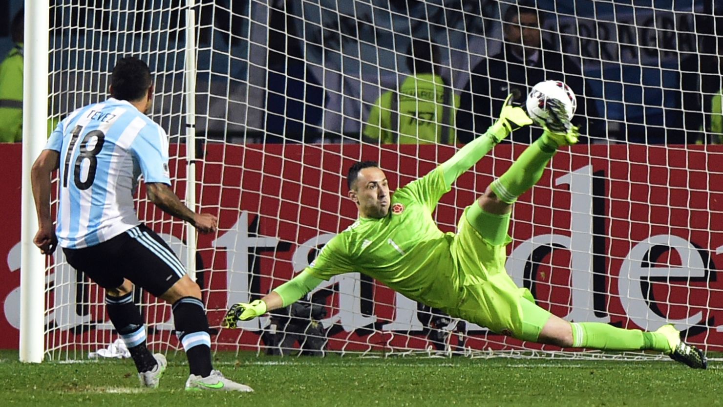 Carlos Tevez scores Argentina's winning penalty past Colombia goalkeeper David Ospina in Vina del Mar.