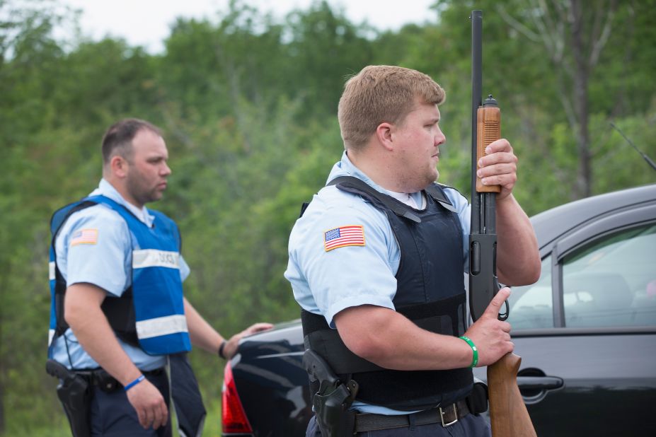 Department of Corrections officers man a roadblock in Malone, New York, on Saturday, June 27.