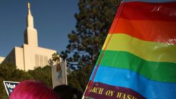 Caption:LOS ANGELES, CA - NOVEMBER 6: Phelan Lecklenburg, 21 months, waves a rainbow flag as she and her lesbian mother Jean MacDonald join hundreds of supporters of same-sex marriage near the Los Angeles Mormon Temple (L) to march for miles in protest against the Church of Jesus Christ of Latter-day Saints November 6, 2008 in Los Angeles, California. The protest, which began outside the Los Angeles Mormon temple, opposes massive financial contributions to the Proposition 8 campaign, which voters passed and which changes the California Constitution to make gay marriage illegal. When same-sex marriages became legal in California on June 16, conservative churches vowed to fight it and successfully passed Proposition 8 with funds that dwarfed that of their opponents. Demonstrators say the Mormon Church contributed some $35 million to pass the measure. (Photo by David McNew/Getty Images)
