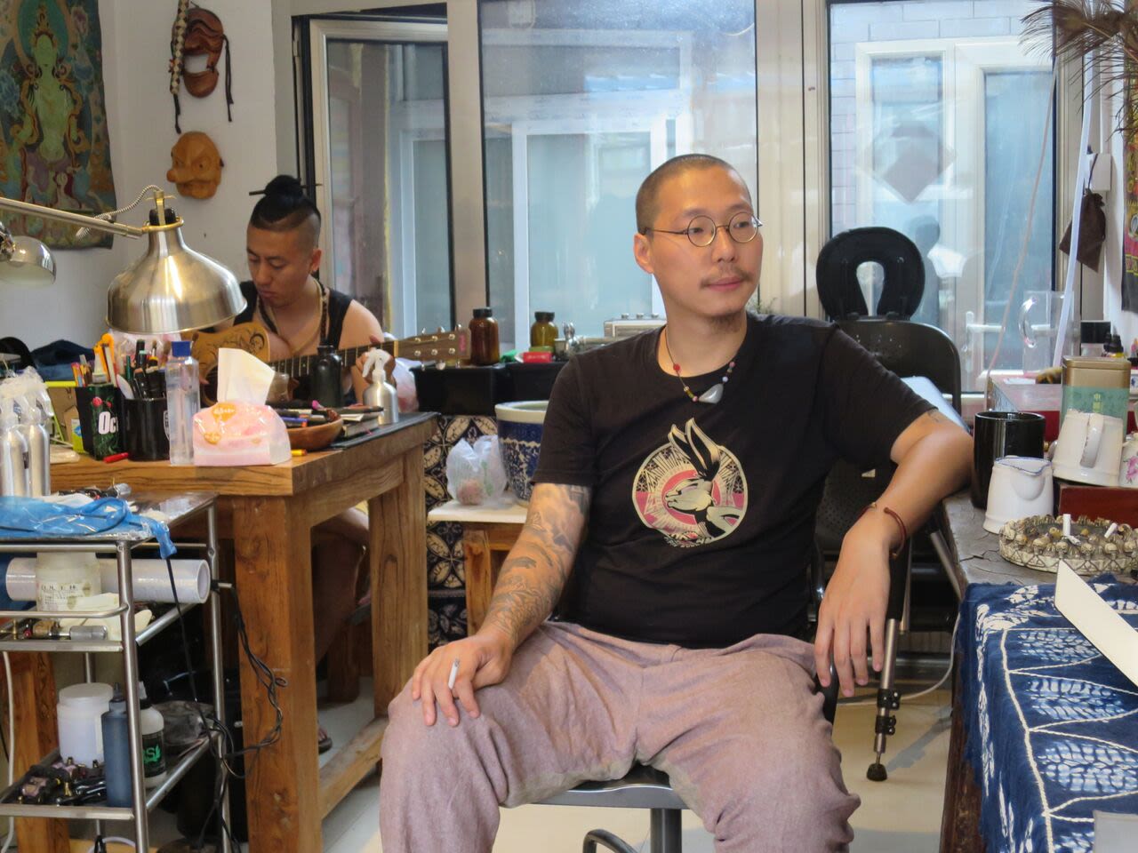 Chinese tattoo artist Da Hua at his studio. He first started out practicing his designs on pig skin bought at the local market.