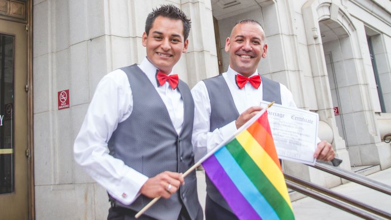 David Herrera-Santos, left, and Carlos Santos-Herrera, right, hold their marriage certificate on the steps of an Atlanta courthouse. Photos by Kelly Embry (<a  target="_blank">www.kellyembryphoto.com</a>).