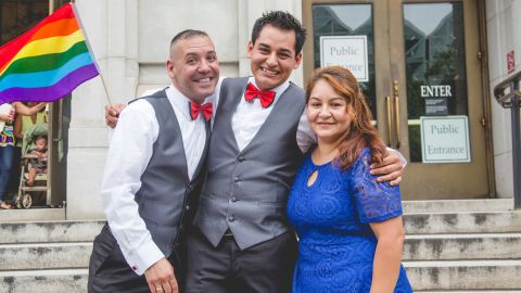 Carlos Santos-Herrera and David Herrera-Santo stand with David's sister, moments after they wed. 