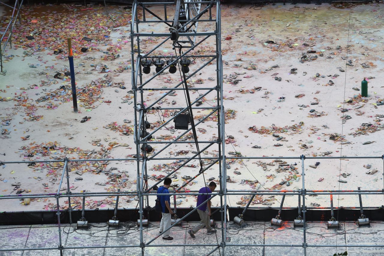 Two men walk at the explosion site of the water park in the Pali district, in New Taipei City, on June 28.