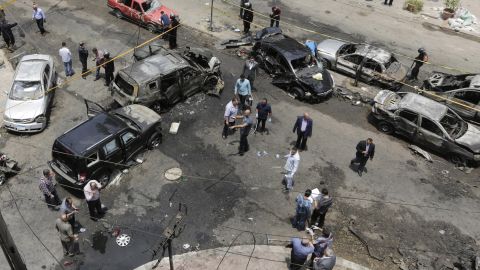 Security personnel check damage Monday in Cairo after an explosion targeted Egypt's prosecutor general.