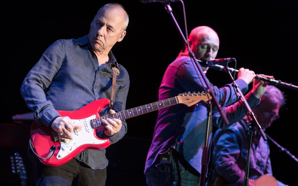 Frontman Mark Knopfler, left, sang to the Live Aid audience about how to get "money for nothing and chicks for free." Seen here, he performs in Paris in 2013.