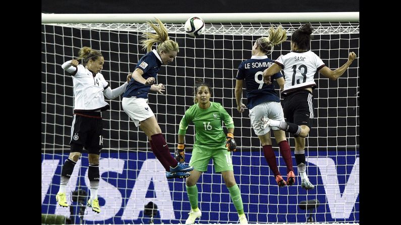 French midfielder Amandine Henry, second from left, jumps for a header while playing Germany in the <a href="index.php?page=&url=http%3A%2F%2Fwww.cnn.com%2F2015%2F06%2F06%2Fsport%2Fgallery%2Fwomen-worlds-cup-2015%2Findex.html" target="_blank">Women's World Cup</a> on Friday, June 26. After the match in Montreal ended 1-1 in extra time, Germany won a penalty shootout to advance to the semifinals.