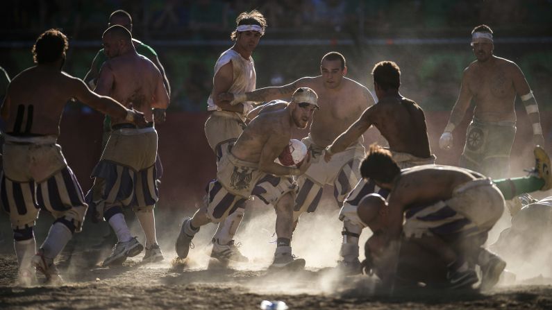 Players fight for possession of the ball while playing Florentine soccer in Florence, Italy, on Wednesday, June 24. <a href="index.php?page=&url=http%3A%2F%2Fcnnphotos.blogs.cnn.com%2F2014%2F01%2F12%2Falmost-anything-goes-in-this-soccer-game%2F" target="_blank">The violent sport has been an annual tradition in Florence</a> for hundreds of years.