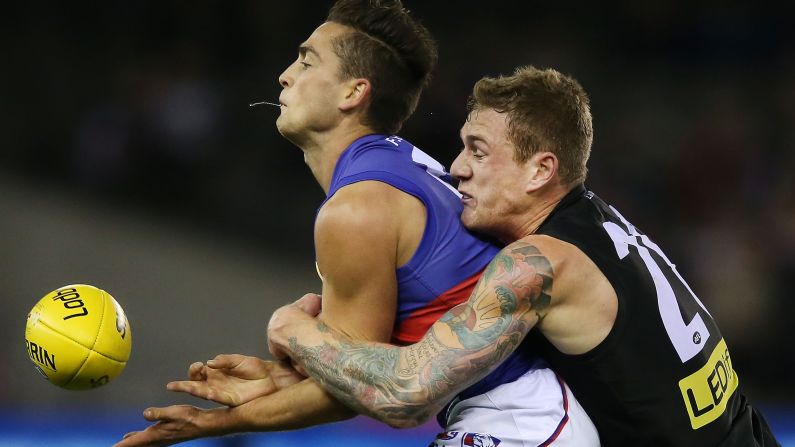 Tim Membrey of the St. Kilda Saints tackles Luke Dahlhaus of the Western Bulldogs during an Australian Football League match in Melbourne on Saturday, June 27.