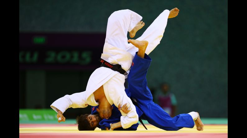 Azerbaijani judoka Orkhan Safarov, in white, competes against Russia's Beslan Mudranov at the European Games on Thursday, June 25. Mudranov won the match to clinch gold in the 60-kilogram (132-pound) weight class.