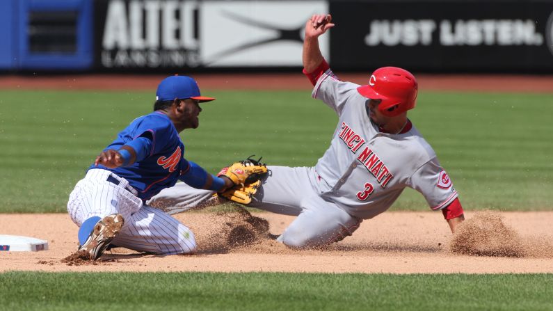 While trying to steal second base, Cincinnati's Ivan DeJesus Jr. is tagged out by Dilson Herrera of the New York Mets on Sunday, June 28.