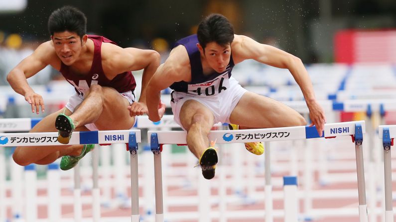 Takumu Furuya, left, and Shunya Takayama race in the 110-meter hurdles during Japan's Track and Field Championships on Sunday, June 28.