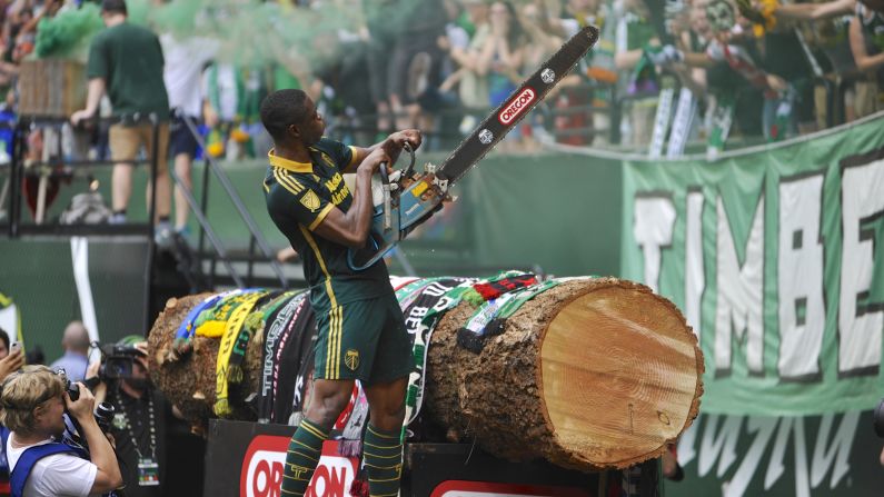 Portland's Fanendo Adi celebrates a goal by picking up a chainsaw on Sunday, June 28. The chainsaw is traditionally wielded by the Timbers' mascot, Timber Joey, who cuts a log slab after each goal.