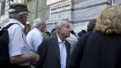 A pensioner reacts as he listens from a bank employee that he is not going to receive his pension after waiting for hours outside the National bank of Greece headquarters in Athens, Monday, June 29, 2015. Anxious Greek pensioners swarmed bank branches hoping to be able to receive their pensions Monday and others lined up at ATMs as they gradually began dispensing cash again on the first day of capital controls imposed in a dramatic twist in Greece's five-year financial saga. (AP Photo/Petros Giannakouris)