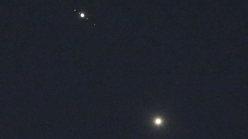 Venus, bottom, and Jupiter shine brightly above Matthews, North Carolina, on Monday, June 29. The apparent close encounter, called a conjunction, has been giving a dazzling display in the summer sky. Although the two planets appear to be close together, in reality they are millions of miles apart.