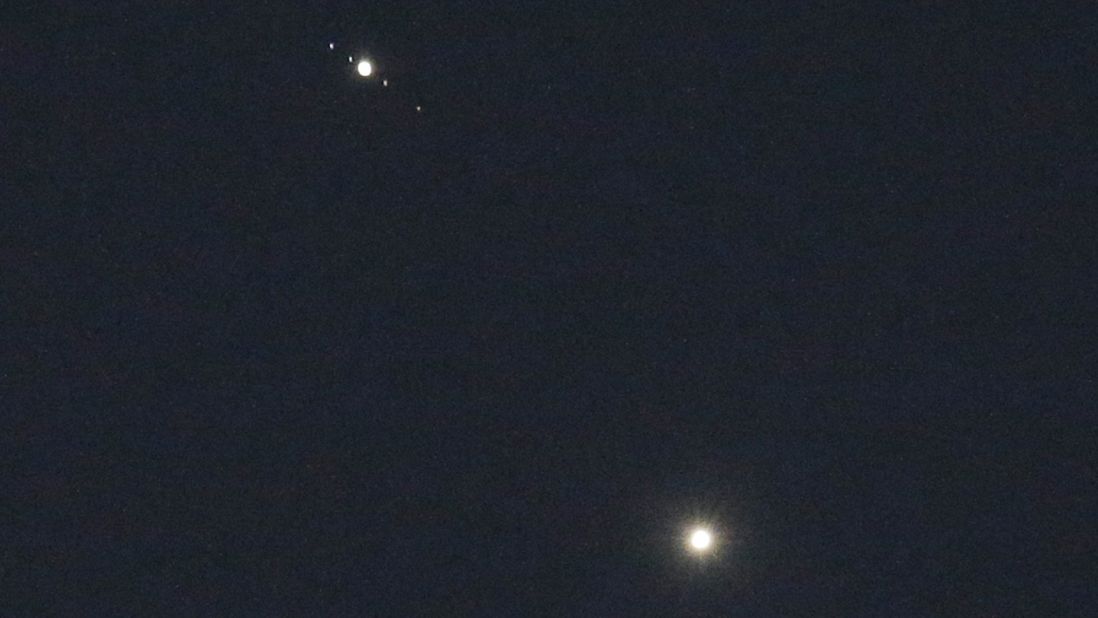 Venus, bottom, and Jupiter shine brightly above Matthews, North Carolina, on Monday, June 29. The apparent close encounter, called a conjunction, has been giving a dazzling display in the summer sky. Although the two planets appear to be close together, in reality they are millions of miles apart.