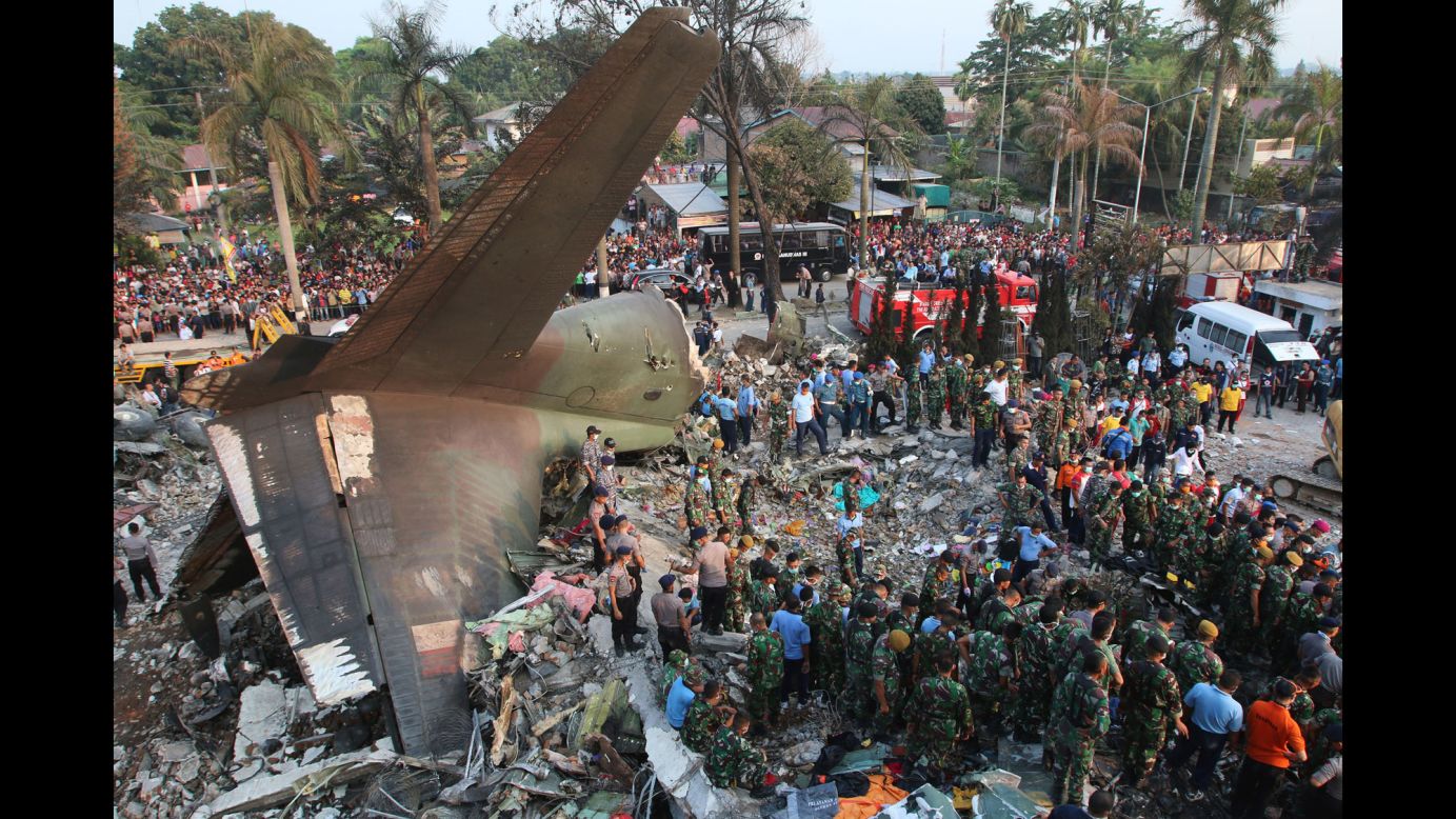 Search and rescue teams work at the site where an Indonesian air force cargo plane crashed in Medan, Indonesia, on Tuesday, June 30.