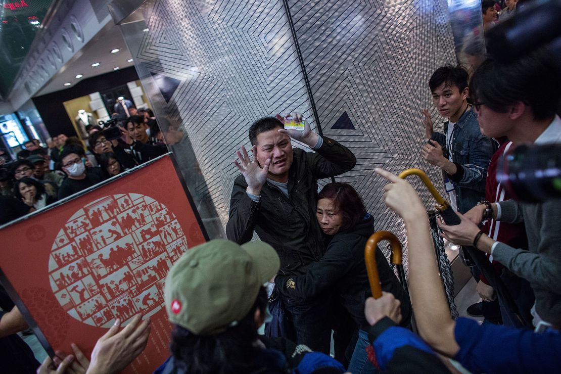 Chinese tourists are surrounded by protesters at New Town Plaza, a shopping mall in Shatin, Hong Kong during a rally against parallel-goods trading on February 15, 2015.