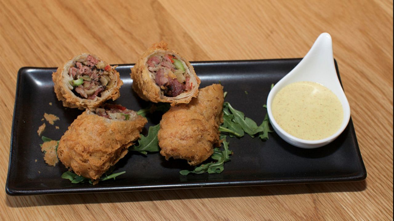 The distinctive dishes found at New York's Red Farm restaurant include Katz Pastrami Egg Rolls, which come with a tasty mustard dip.