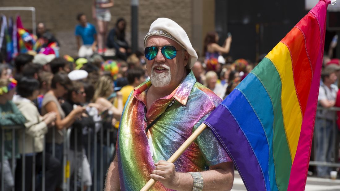 Rainbow flag creator Gilbert Baker marches during the 2015 San Francisco Pride Parade. Baker says he wept when the Supreme Court announced its decision making same-sex marriage legal nationwide.