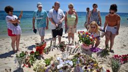 Holidaymakers lay flowers on Marhaba beach, where 38 people were killed in a terrorist attack last Friday, on June 30, 2015 in Sousse, Tunisia.