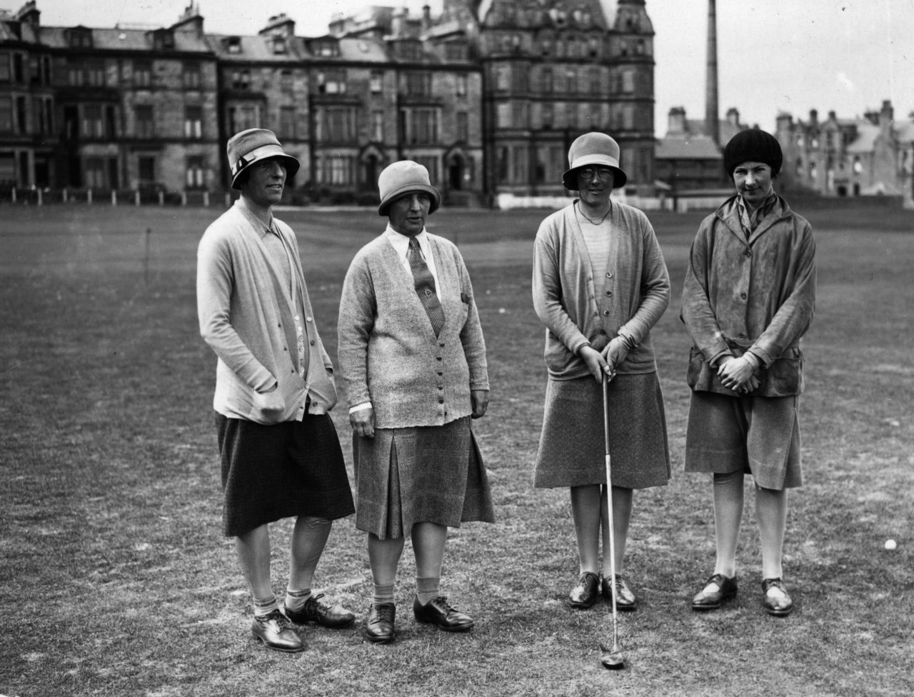 Four first-round competitors in a Ladies' Scottish Foursomes tournament on the Royal and Ancient Course in June 1928.<br /><br />Women golfers would sometimes wear what was called a "Miss Higgins Hoop."<br /><br />"It was really just a piece of elastic that was moved up to around their knees and designed to keep your skirt from blowing up in the wind -- women had to remain modest. Often what would happen is that they would weight their skirts with wire along the bottom edge rather than having the Miss Higgins Hoop," Fleming says. <br /><br />"During the 1920s and 1930s women's fashion in general changed -- there was less corsetry -- so golf fashion kind of reflects wider fashions."