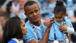 Vincent Kompany the captain of Manchester City lifts his daughter Sienna alongside his wife Carla following the Barclays Premier League match between Manchester City and Queens Park Rangers at Etihad Stadium on May 13, 2012 in Manchester, England. (Photo by Alex Livesey/Getty Images