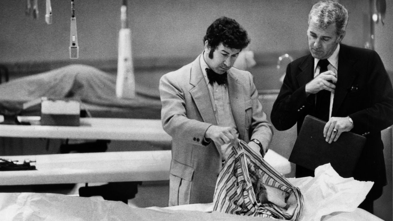 Homicide inspectors David Toschi, left, and William Armstrong go through a "Zodiac Killer" victim's clothes looking for clues. "In the '70s there was a certain kind of killer who had the skill to get away with murder long enough to assemble the body count where they would be classified as serial killers," said James Alan Fox, the author of "Mass Killing." The Zodiac Killer has never been caught.<br />