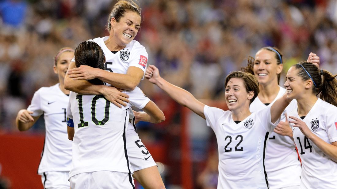 American Kelley O'Hara, top, celebrates with teammates after scoring a goal against Germany on Tuesday, June 30. The goal, late in the second half, clinched a 2-0 semifinal victory for the Americans in Montreal.