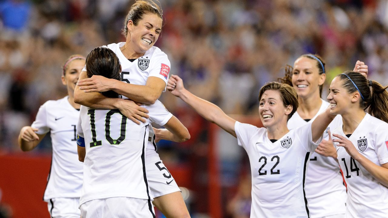 American Kelley O'Hara, top, celebrates with teammates after scoring a goal against Germany on Tuesday, June 30. The goal, late in the second half, clinched a 2-0 semifinal victory for the Americans in Montreal. 