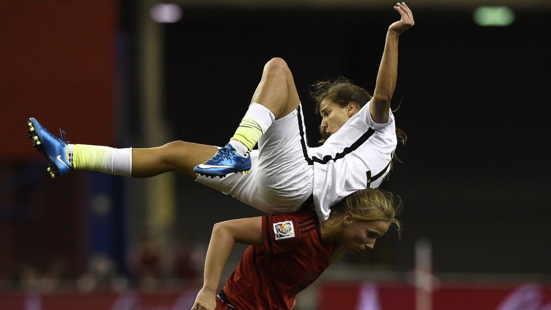 U.S. midfielder Tobin Heath gets knocked over by Germany's Tabea Kemme.