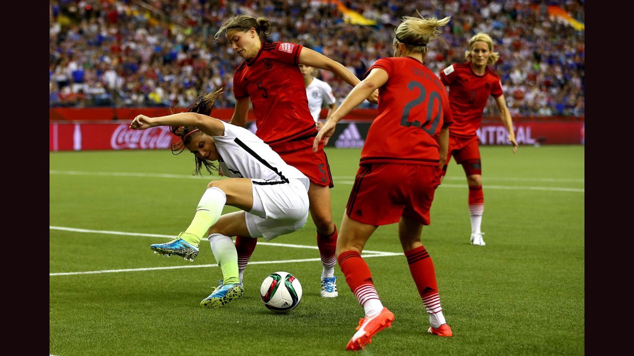 Alex Morgan of the United States is defended by Germany's Annike Krahn, left, and Lena Goessling.