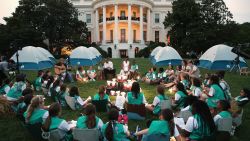 US President Barack Obama and First Lady Michelle Obama talk with Girl Scouts that are camping overnight on the South Lawn of the White House in Washington, DC, June 30, 2015. Fifty Girl Scouts will spend the night on the White House lawn in camping tents as part of the 'Let's Move' campaign to fight childhood obesity and increase nutrition awareness.
